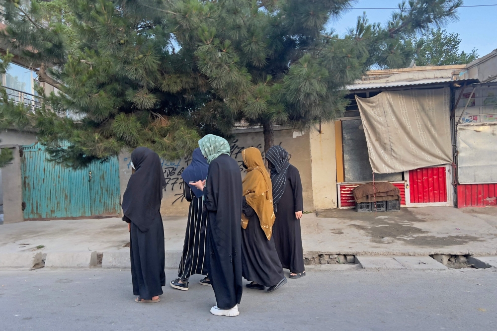 In this photo taken on June 26, 2024, Afghan women walk along an early morning street in Kabul. - AFP picture 