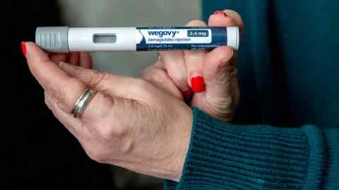 A person holding a Wegovy vaccine